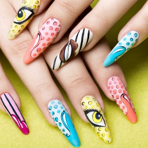 Long beautiful manicure in pop-art style on female fingers. Nails design. Close-up