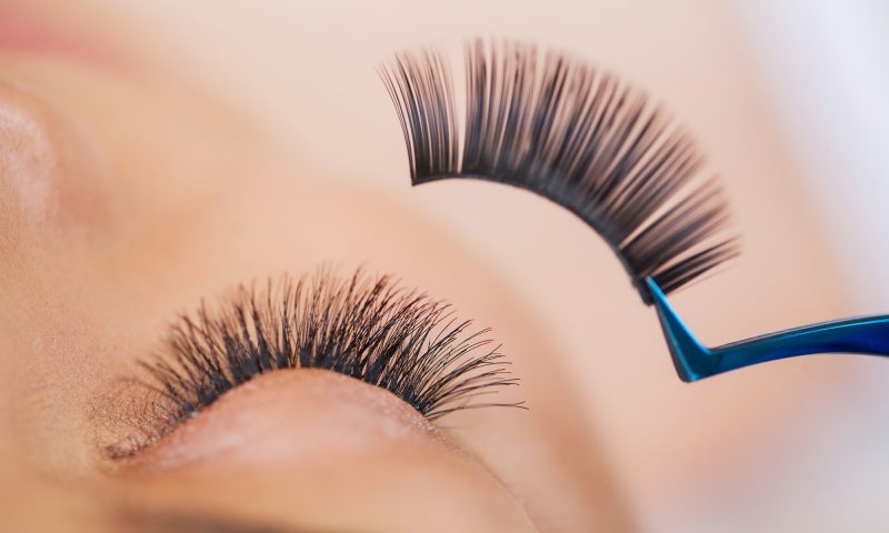 Woman Eye with Long Eyelashes. Beautiful Young Woman During Eyelash Extension